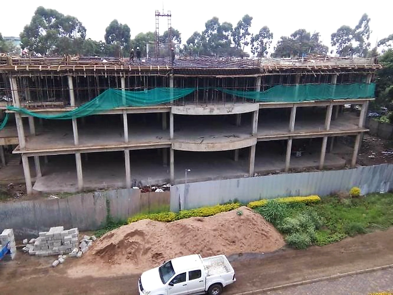 Reinforced concrete frame under construction on a college campus